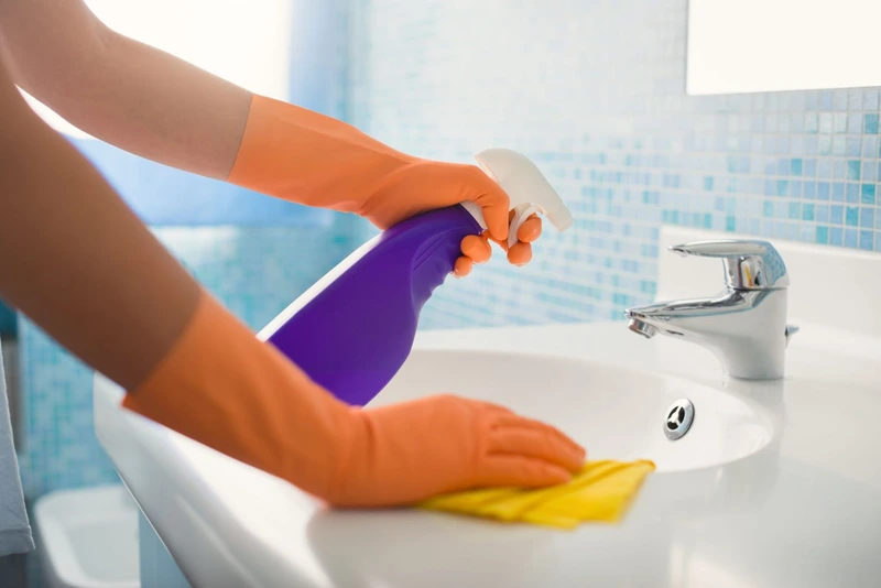 cleaning and disinfecting bathroom sink and faucet professionally