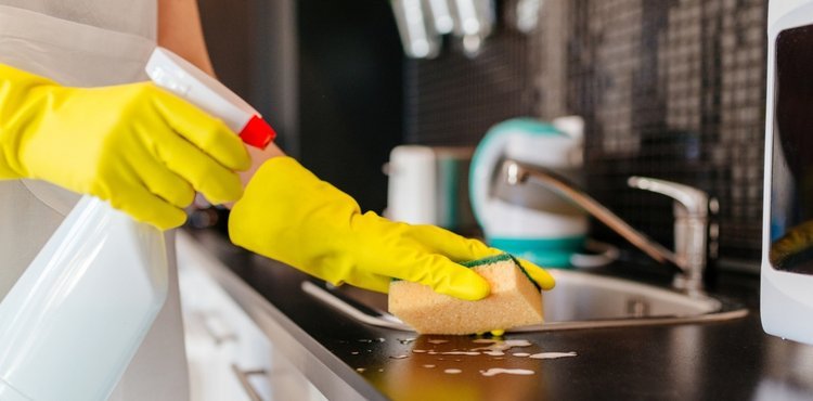 professional cleaner cleaning kitchen during deep cleaning service in Maryland