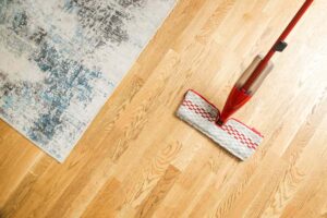 professional cleaner maintaining hardwood floors in Maryland home