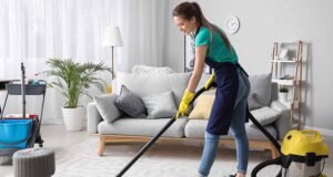professional house cleaner vacuuming Maryland home living room